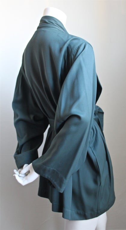 Gorgeous muted teal wrap jacket with belted waist from Assedine Alaia dating to the 1980s. There is no size indicated, although this jacket fits a size XS-M due to loose cut. Unlined. One interior pocket. Made in France. Excellent condition. Same