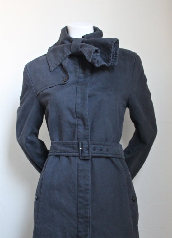 Slated toned brushed cotton trench with bow detail at neck from Viktor & Rolf. Fits a size 2 or 4. Button closure. Fully lined. Made in Italy. Excellent condition.