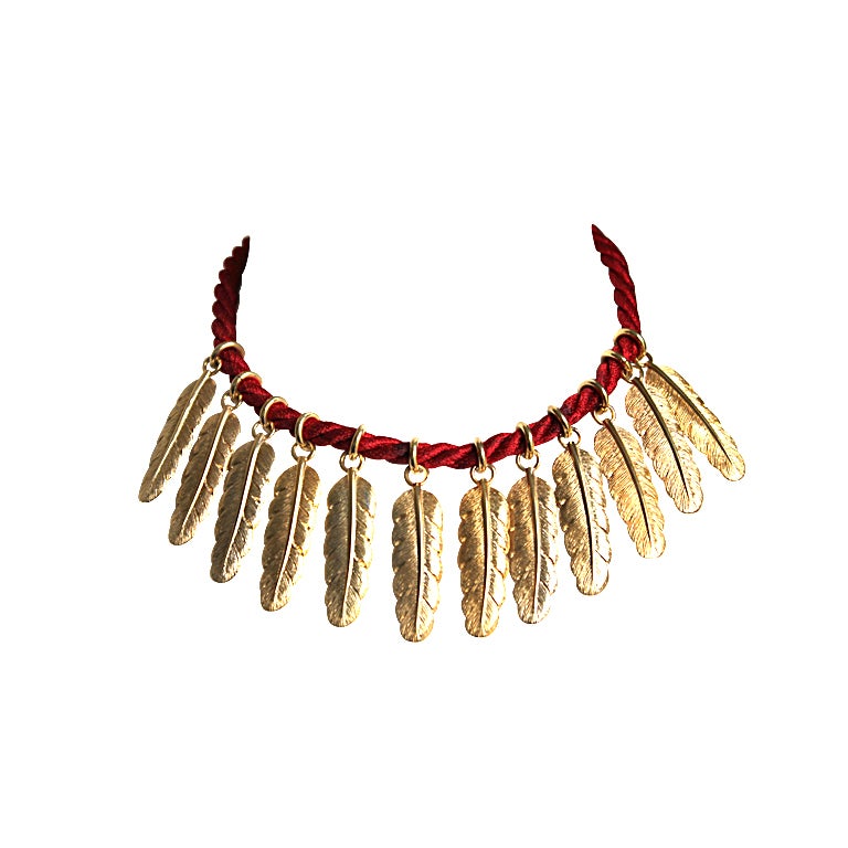 YVES SAINT LAURENT gilt feather necklace on cord