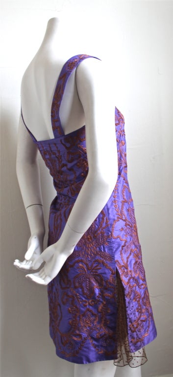 Rich purple silk dress with golden embroidery and tulle detail from Valentino dating to the late 1980's. Fits a size 0 or 2 (31-32