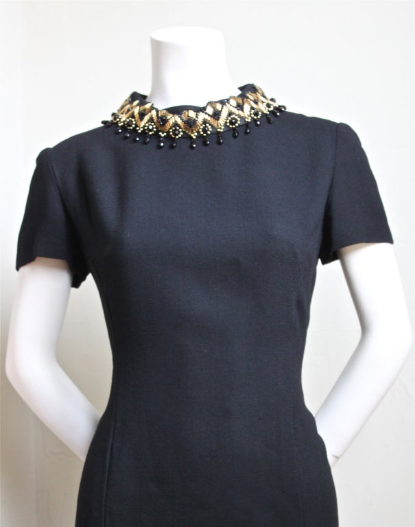 Jet black wool couture dress with beaded collar from Balmain dating to the 1960's. Fits a size 6-10. Dress measures approximately 37