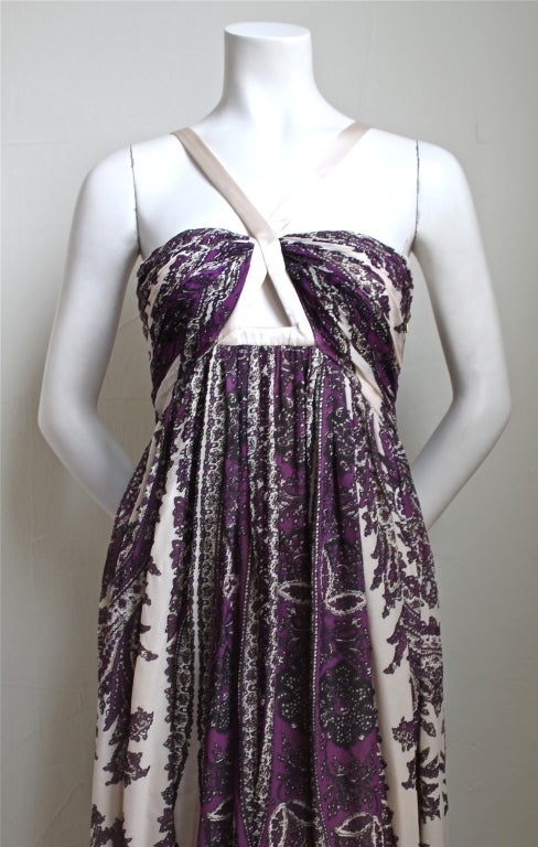 Gorgeous paisley printed silk floor length gown with satin straps from Roberto Cavalli. Colors are purple, black and a light blush shade with gold metallic shades throughout. Labeled an Italian size 44 (runs small), which best fits a US 4 or 6. Made
