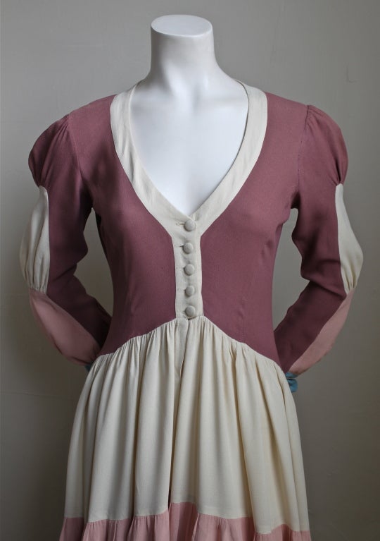 Very rare tiered moss crepe dress from Ossie Clark for Quorum dating to the 1970's. Fits a US 2-6 (moss crepe has some give). Colors are mauve, cream, blush and robin egg blue. Button front closure at bodice. Made in the UK. Good condition.