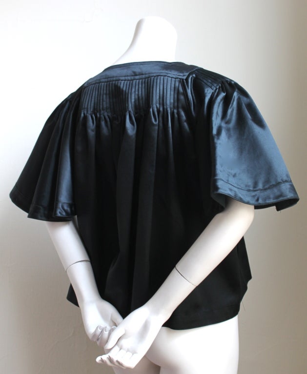 Very rare pleated jet black satin jacket from Ossie Clark for Quorum dating to the 1970's. Labeled a UK 14 which best fits a US 4-8. Made in the U.K. Very good condition.