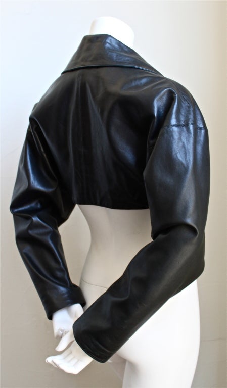 Jet black cropped leather jacket with single button closure from Azzedine Alaia dating to the 1980's. Labeled a French size 36. Fully lined. Made in France. Excellent condition.