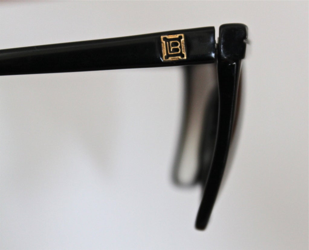 Jet black sunglasses with abalone trim from Laura Biagotti dating to the 1980's. Very good condition.