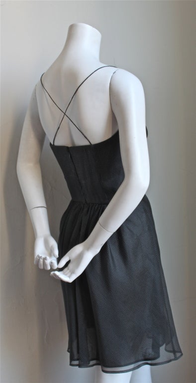 Black silk bustier dress with polka dots from Giorgio Armani dating to the late 1980's. Italian size 38. Padded bustier which best fits a B or C cup. Fully lined. Back zip. Made in Italy. Excellent condition.