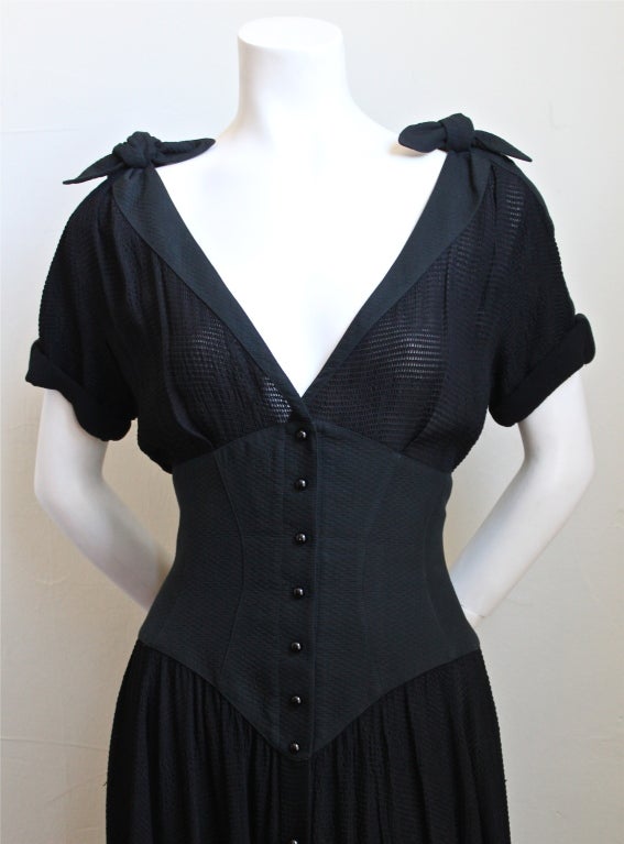 Very rare semi sheer black gown with cotton corset from Thierry Mugler dating to the 1990's. Best fits a size 6-8. Made in France. Snap closure. Excellent condition.