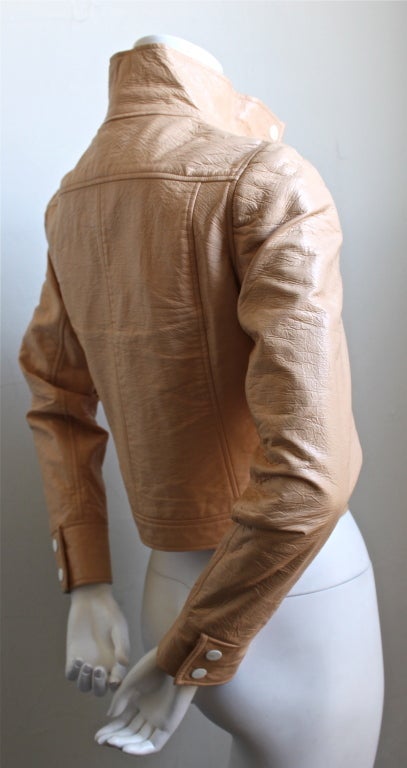 Very rare peachy/tan colored vinyl jacket with white accents from Courreges dating to the 1960's. Labeled a size 'A', which best fits a size 2 or 4 (33