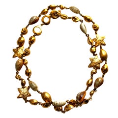YVES SAINT LAURENT extra long gilt necklace with shells
