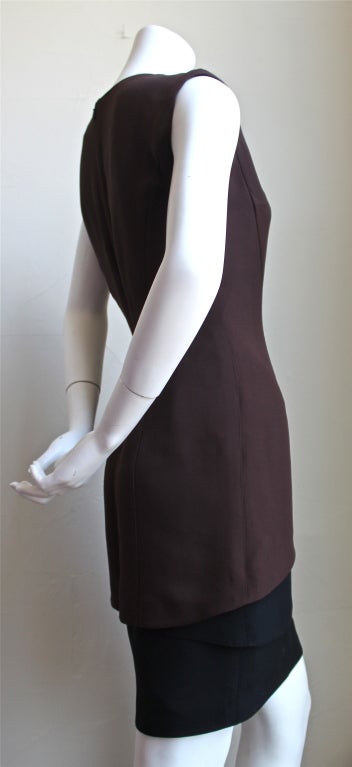 Rich brown and black sculpturally cut dress with high neck and cap sleeves from Thierry Mugler dating to the 1990's. Labeled a French size 38, although this runs especially small in the hips. Zips up center back. Fully lined. Made in France.