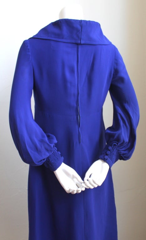 Very rare silk haute couture dress with ruching from Pierre Balmain dating to the 1960's. Color is a purple-blue shade and the fabric is a delicate silk.  Fits a size 4-6. Zips up center back. Fully lined. Very good condition with some of the