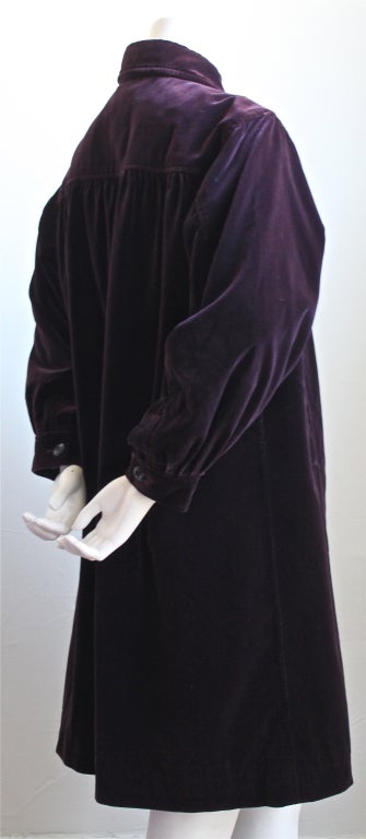 Beautiful plum silk velvet coat from Yves Saint Laurent dating to the 1970's. Labeled a size FR 34, although this coat can easily fit up to a US 4/6 due to the loose cut. Fully lined. Pockets at hips Made in France. Excellent condition.
