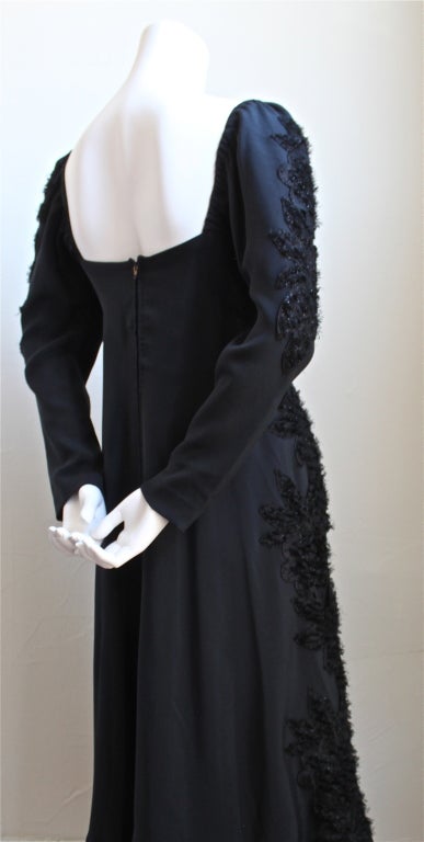 Beautifully cut jet black silk dress with unique floral trim made by Stavropoulos dating to the 1970's. Dress best fits a size 4/6. Approximate measures: bust 32