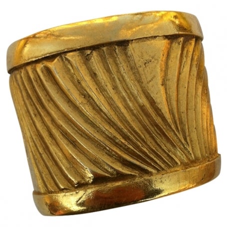 Very unique organically shaped heavy gilt cuff from Yves Saint Laurent dating to the 1980's. Fits a small to medium wrist. Made in France. Excellent condition.
