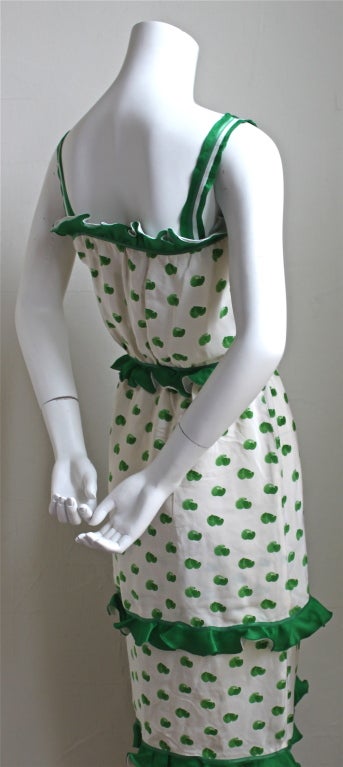 Beautiful green and off-white abstract printed silk dress with ruffles from Courreges dating to the 1973. Labeled a Courreges '00' which fits a size 0/2 (very narrow at top of bodice). Zips up side with invisible zipper. Fully lined. Made in France.
