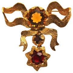 Vintage YVES SAINT LAURENT gilt ribbon brooch with faceted glass stones