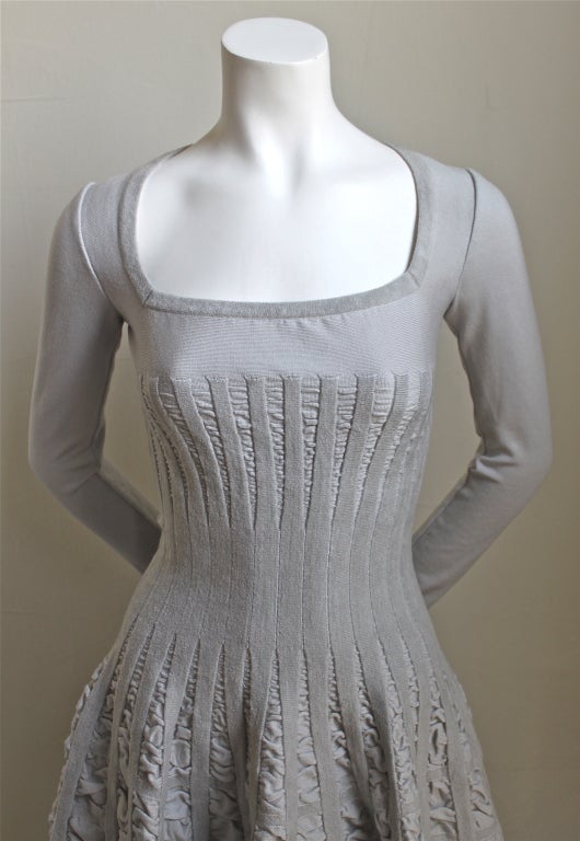 Gorgeous dove grey knit dress with full skirt detained with panels of ruching and chenille trim from Azzedine Alaia. Labeled a French size 38 which best fits a US S. Dress measures approximately (un-stretched) 32