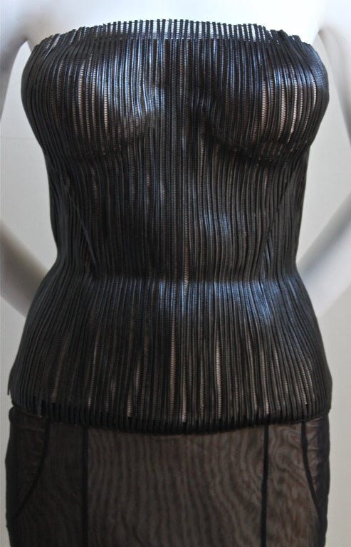 Very rare leather and mesh bustier with mesh skirt designed by Tom Ford for Gucci dating to 2001. Both pieces are labeled as Italian size 40. Bustier measures approximately: 32