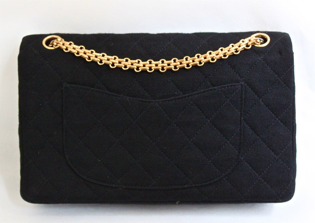 Very rare classic black wool jersey quilted '2.55' bag with gilt hardware from Chanel dating to the 1960's.  Bag measures approximately  10