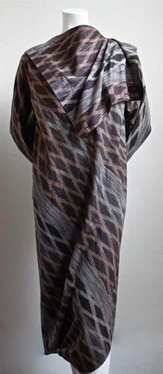 Gorgeous finely woven manganese treated 'Kasuri' (Japanese ikat) dress with asymmetrical hemline and draped collar with original contrasting fabric jacket from Issey Miyake dating to 1982. Labeled a size medium. Measures approximately 19.25