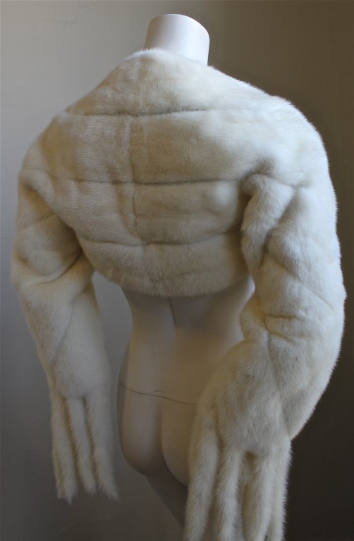 Gorgeous ivory mink fur shrug as sell on the runway Fall 2004.  Fits a size 4 or 6. Fully lined in graphic silk print lining. Made in Italy. New with tags.