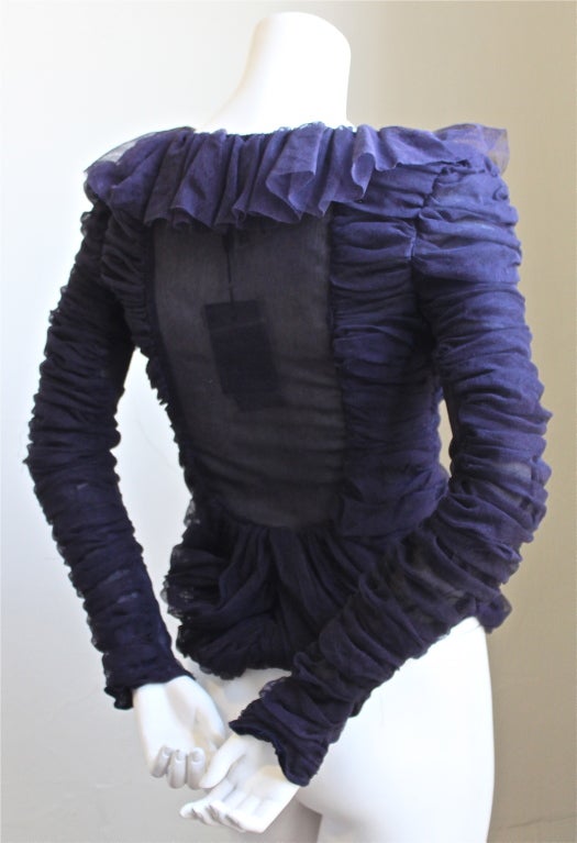 Ruffled purple net blouse designed by Tom Ford for Yves Saint Laurent. Labeled a French size 36. Zips up center back. Made in Italy. New with tags with a few snags which are completely hidden.