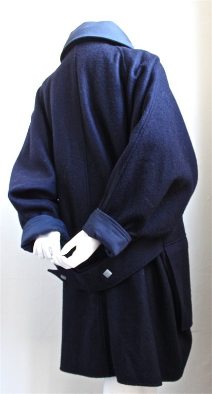 Uniquely shaped navy wool felted wool coat with large metal snaps from Anne Marie Beretta dating to the 1980's. Labeled a size 2, which best fits a size 6-10. Cotton lining at collar and cuffs. Oversized pockets at hips. Made in France. Excellent