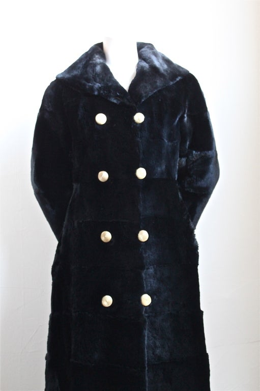 Jet black sheared fur full length coat with gold buttons designed by Revillon for Saks Fifth Avenue dating to the 1950's. Fits a size 2 or possibly a 4. Coat measures 33