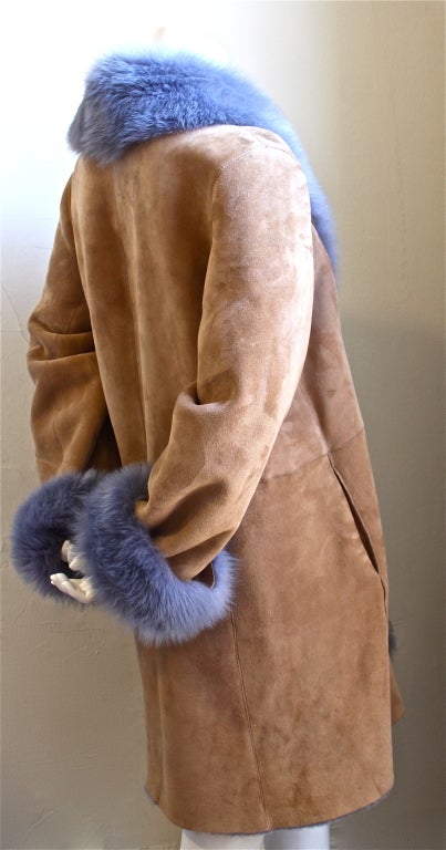 Custom made tan and purple reversible shearling coat with fox trim. Fits a size 8 or 10. Approximate measurements are as follows" 42" bust, 17" shoulder, 27" arm length un-cuffed and overall length 38". Made in the U.S. Very
