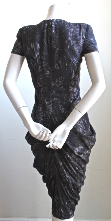 Very unique fox printed draped dress with strong padded shoulders and deep V neckline from Alexander McQueen dating to spring 2010. Italian size 42, which best fits a size 4 or 6. Bust: 34
