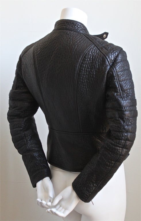 Jet black heavy leather moto jacket with heavy silver hardware and red quilted lining designed by Phoebe Philo for Celine. Labeled a French size 40 although this jacket runs very small - it best fits a French size 38 or even a French 36. Here are