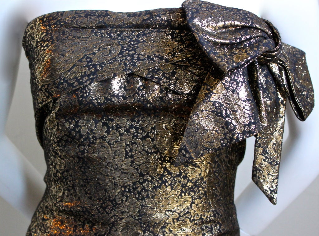 Gorgeous metallic bronze floral strapless dress with offset bow detail designed by Lanvin dating to the early 1980's. French size 42, which best fits a size 8 to 10. Approximate measurements: bust 35