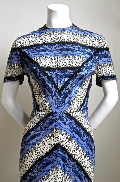 Very rare printed silk dress with elaborate piecing, pleating at bust, chevron mitering and full length back flounce from Gilbert Adrian dating to the 1940's. The details are amazing and the hand finishing is exquisite. Dress best fits a size 2 or