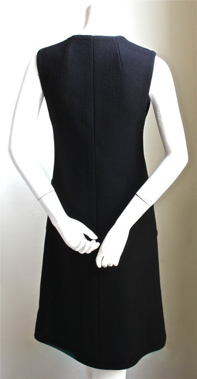 Jet black mod A-line wool dress with patch pockets from Lanvin dating to the 1960's. Fits a size 4. Approximate measurements: bust 33