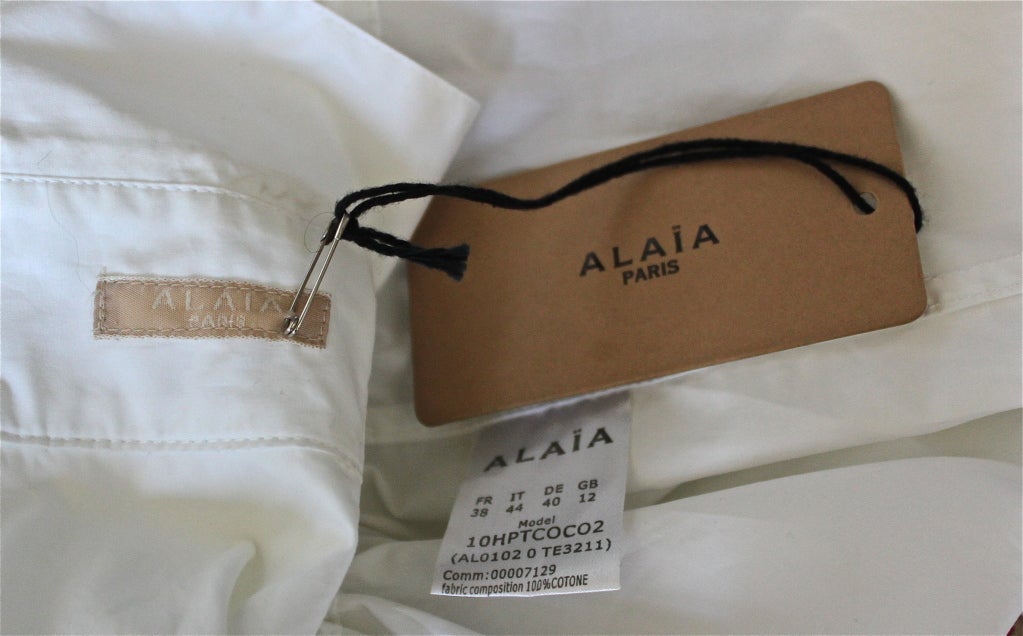 Unworn white cotton poplin minidress from Azzedine Alaia. Labeled a French 38, although fits a size 0 or 2. Very narrow through bust and very short. Made in Italy. New with tags.