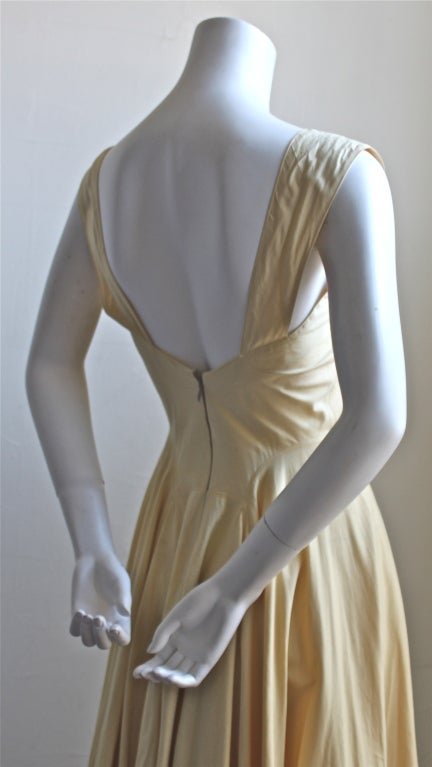 Very rare long pale yellow cotton blend dress with full skirt and open back from Azzedine Alaia dating to the early 1980's. Fits a US 2. Bust measure about 32