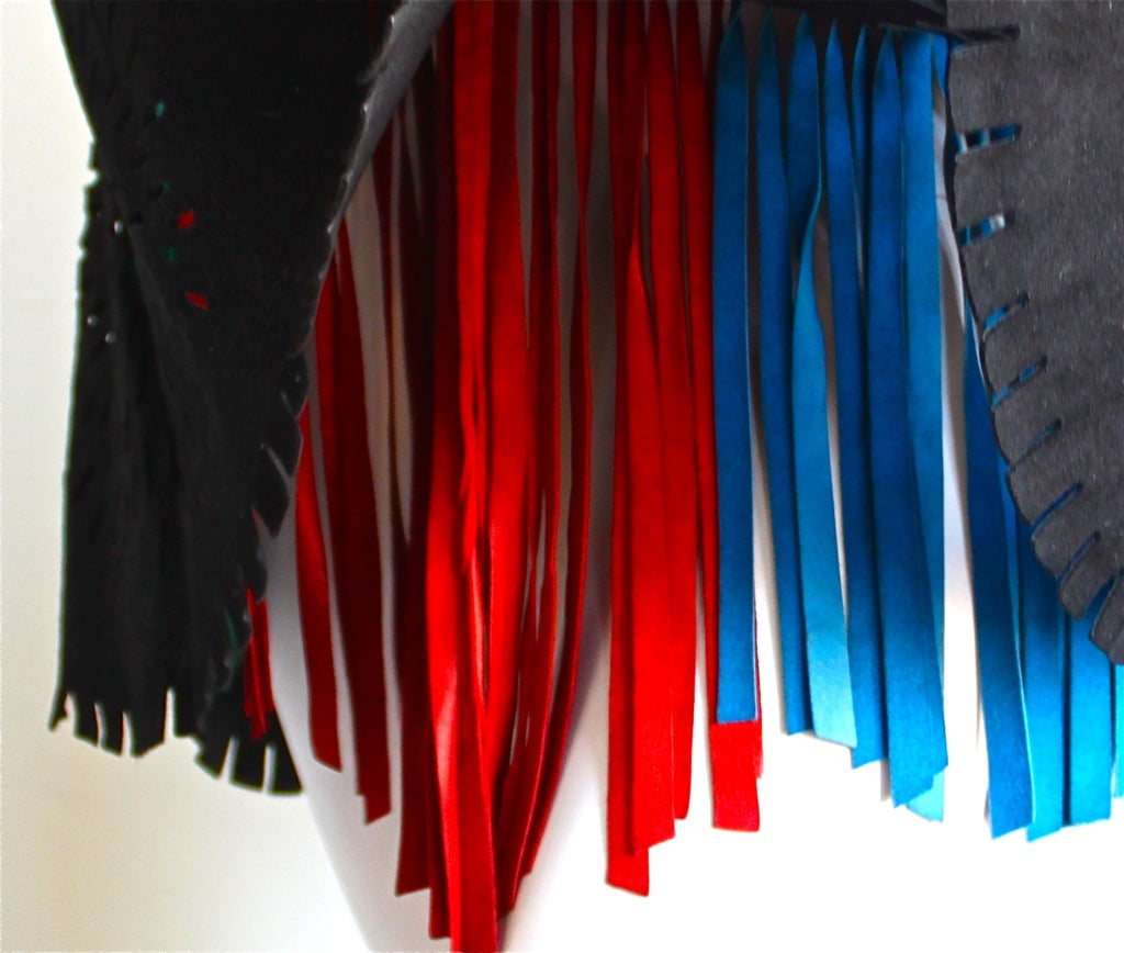 Very rare jet black suede laser cut skirt with colorful fringed leather underlay from Azzedine Alaia dating to 1994. Fits a size 4 (26