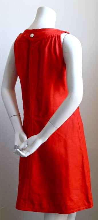 Very rare vivid orange linen A line couture dress with patch pockets from Courreges dating to the 1960's. Fits a size 6 or 8. Made in France. Very good condition (light discoloration at back and some wear to enamel snaps).