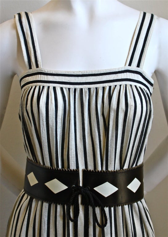 Gauzy natural and black striped cotton peasant dress designed by Yves Saint Laurent dating to the 1970's. Labeled a French size 34, which best fits a size 0 or 2. Band above bust is very small measuring approximately 30