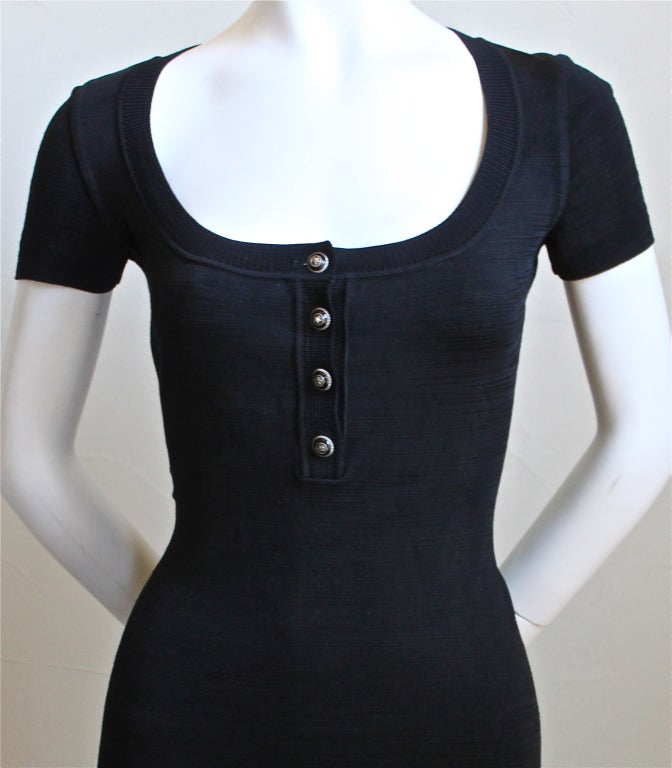 Textured jet black slinky knit dress with enameled star buttons form Azzedine Alaia dating to the 1990's. Fabric is cool to the touch. No size indicated but best fits a size M. Approximate measurements unstretched are: bust 34.5