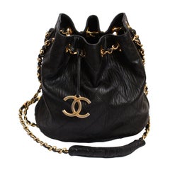 1980's CHANEL black quilted leather bucket bag with gilt chain