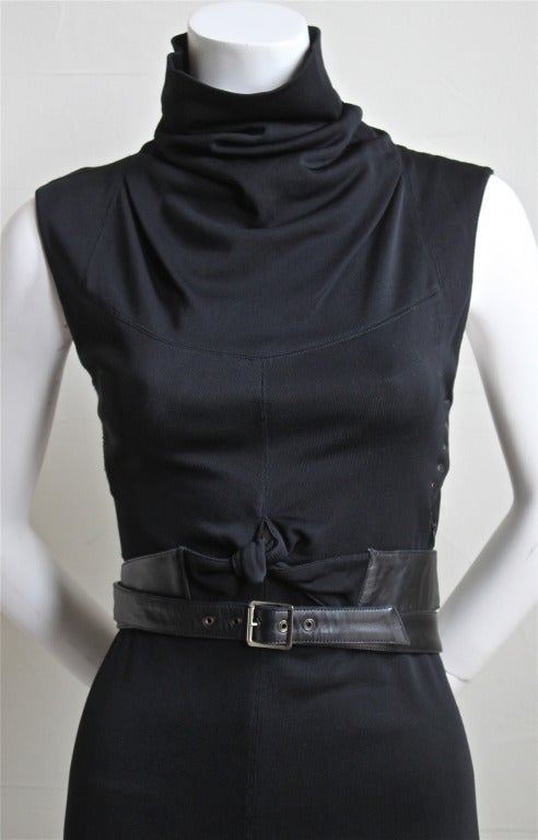 Jet black viscose knit jersey dress with unique wrapped black leather belt from Alaia dating to the late 1990's. Fits a size S. Approximate unstretched measurements: bust 30
