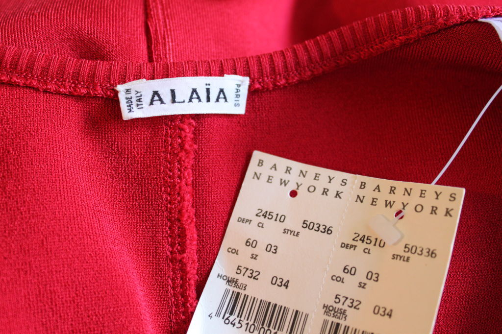 Vibrant red knit dress with spaghetti straps and set in waistband from Azzedine Alaia dating to the 1990's. Labeled a size 'L', although this would fit a medium best. Approximate measurements: bust 34