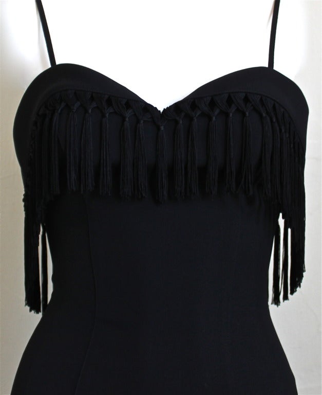 Jet black fitted dress with dramatic fringed trim from Thierry Mugler dating to the early 1990's. Labeled a French size 38. Bust 32.5-33, waist 27', hips 36