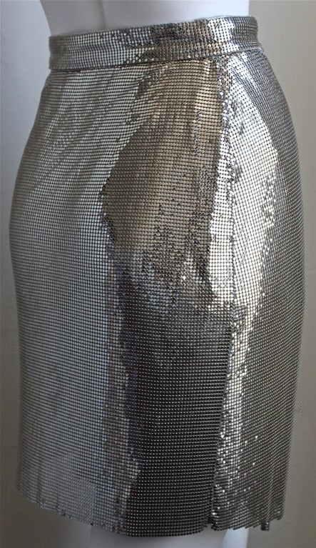 Very rare silver Oroton chain mail draped skirt from Gianni Versace Couture dating to 1994. Labeled an Italian size 40. Approximate measurements: waist 25