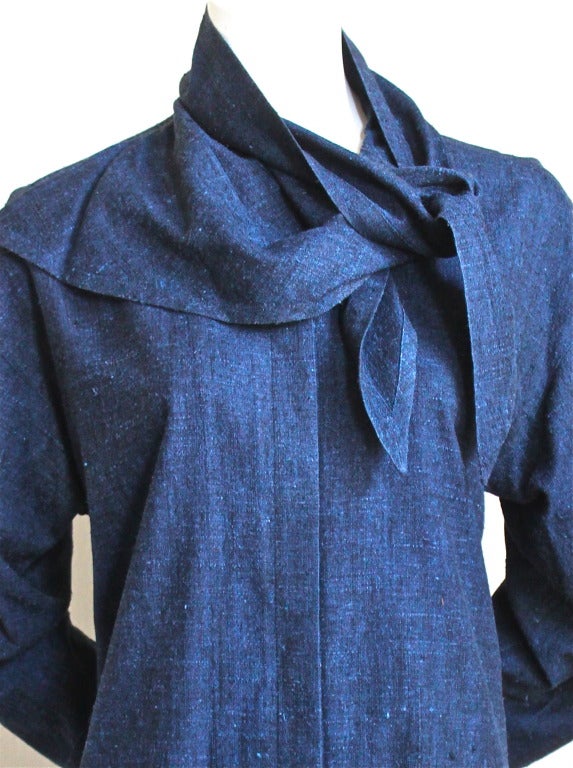 Unusual indigo raw silk shirt with draped neckline from Issey Miyake dating to the early 1980's. Labeled a size 'S'. Concealed button front closure. Buttons at wrists. Made in Japan. Excellent condition.