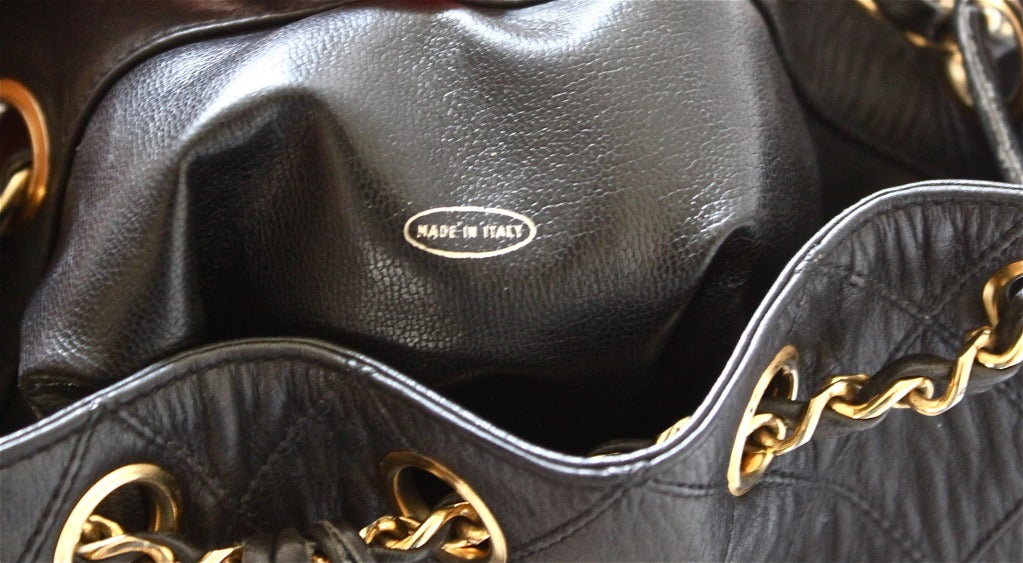 Women's 1980's CHANEL black quilted leather bucket bag with gilt chain