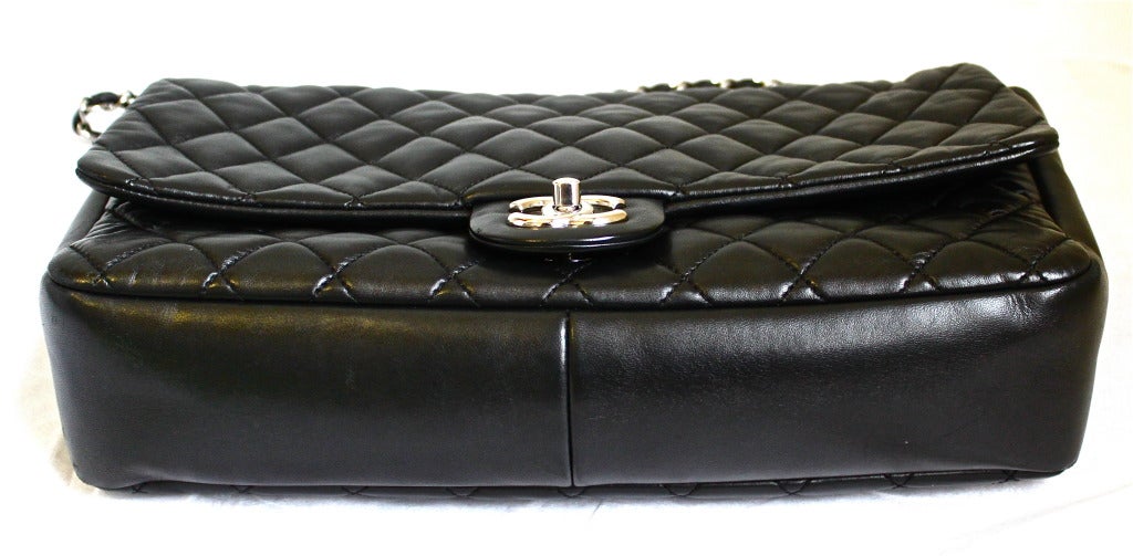 Classic jet black lambskin quilted leather 'UNI' bag with silver hardware from Chanel. Leather is very soft and flexible. Size is approximately 13