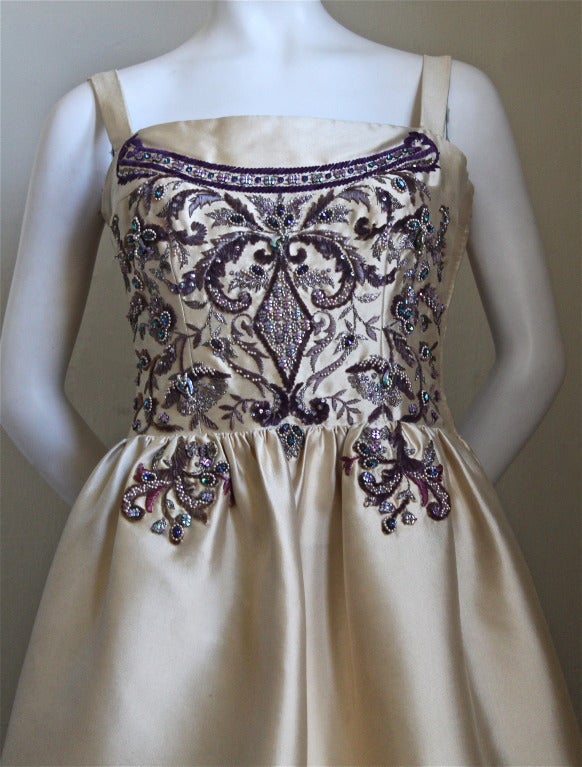 Extremely rare champagne silk gown with chenille and diamante embroidery designed by Antonio del Castillo for the couture house of Lanvin dating to 1957. Intricate embroidery and beadwork was done by the house of Lesage. Phenomenal attention to